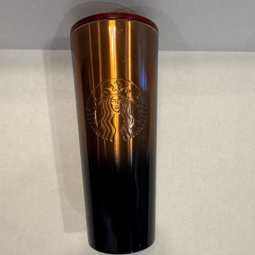 Starbucks Copper colored tumbler that transitions to a black bottom